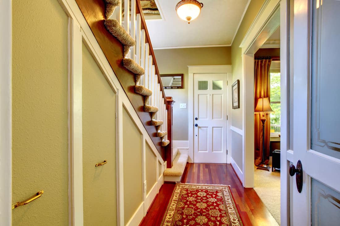 A rustic themed house, traditional designed door and protruding staircase, How to Decorate a Split Level Entryway [6 Suggestions]