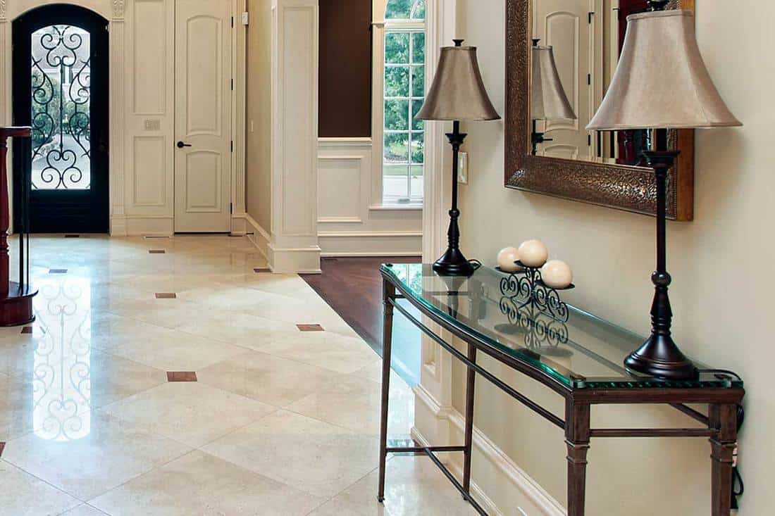 Foyer of a luxury home with entryway table and mirror, How To Style Entryway Table? 6 Interior Design Styles Suggested