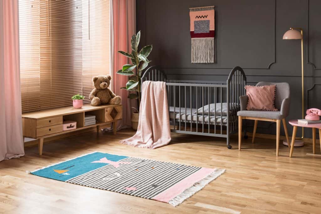 Grey colored crib inside a nursery room