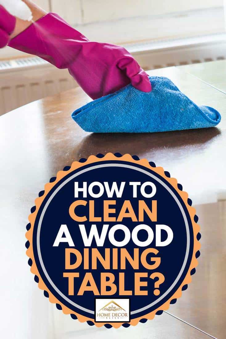 Woman cleaning wooden table with cloth and spray cleaner, How to Clean a Wood Dining Table