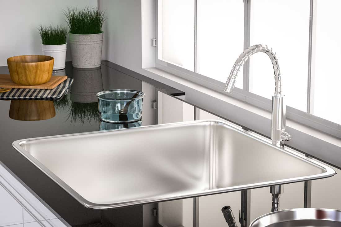 Interior of a modern domestic kitchen with water faucet closeup, How long do kitchen sinks last