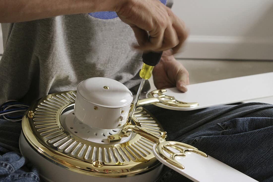 Man assembling a ceiling fan