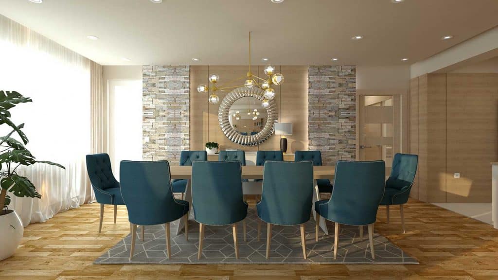 Modern dining room with blue chairs, round mirror and chandelier