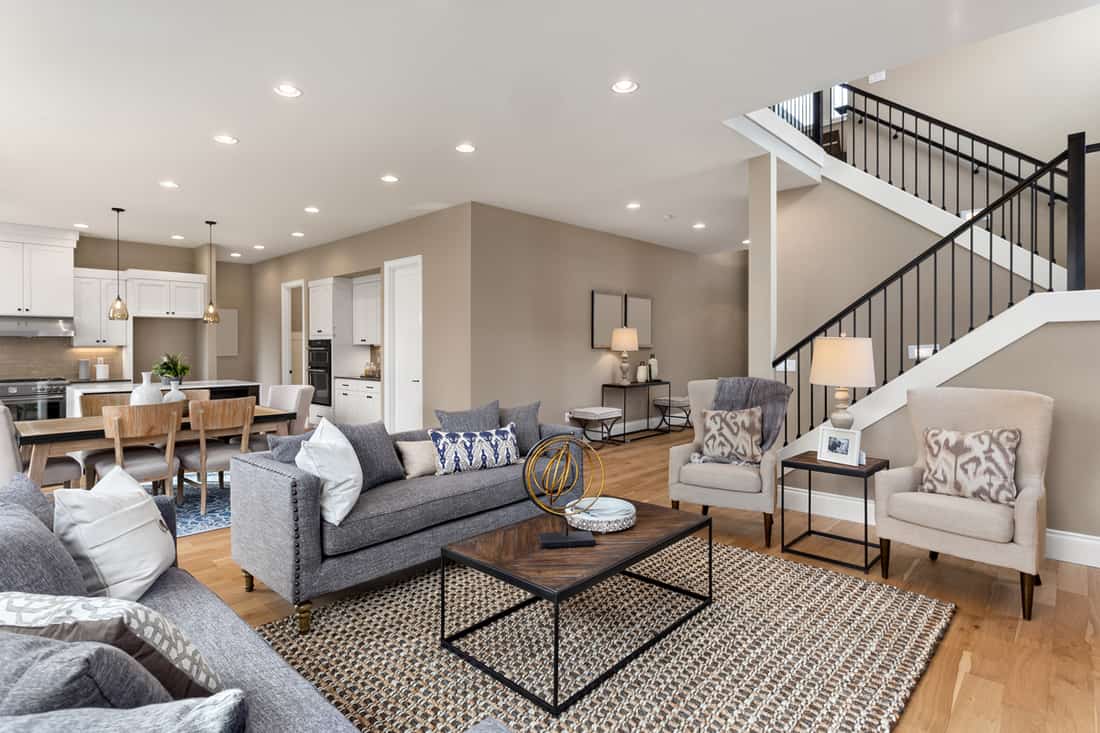 Modern living room with a gray touch to it combined with the colors brown on the flooring and gray to the furnitures, Should Ceiling Paint Match Trim? [Design Options Explored]