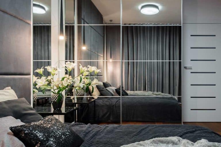 New design bedroom with bed, mirrored wardrobe and modern painting, Should Bedroom Curtains Be Long or Short?