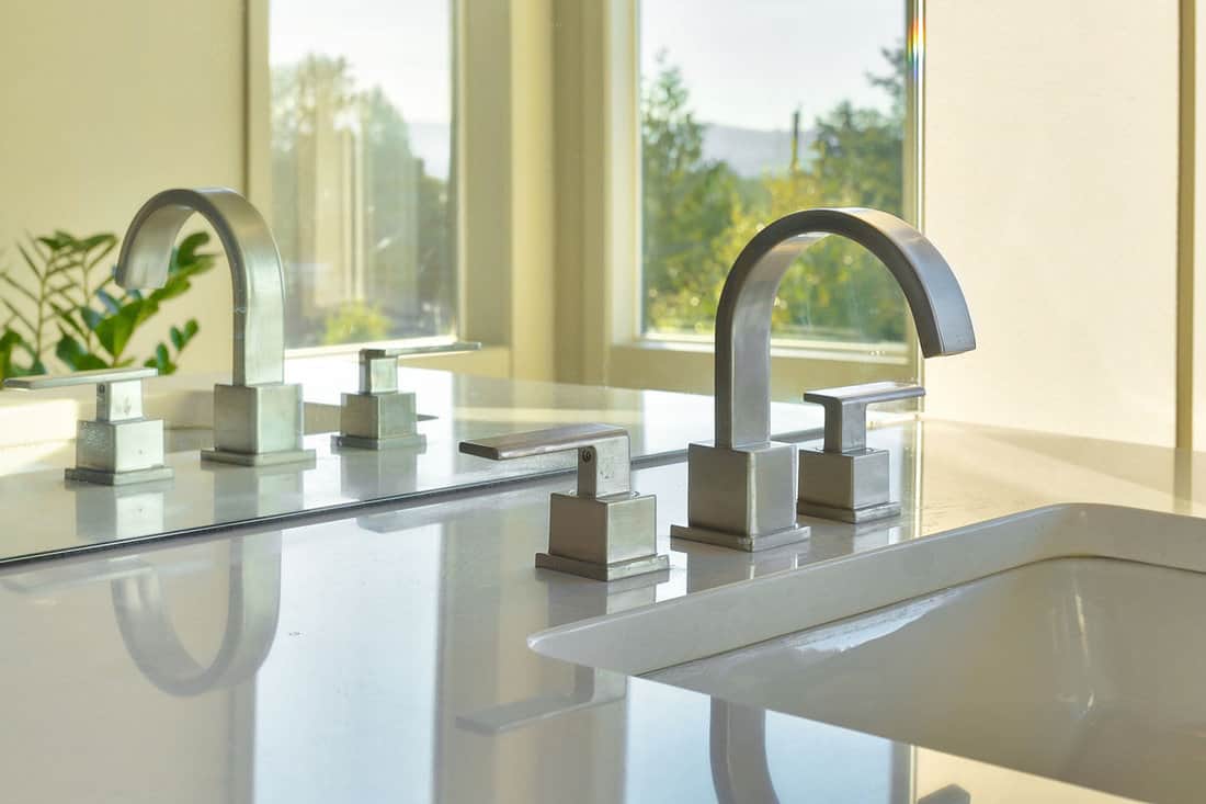 Sink and Reflection in Modern Bathroom of a centerset faucet