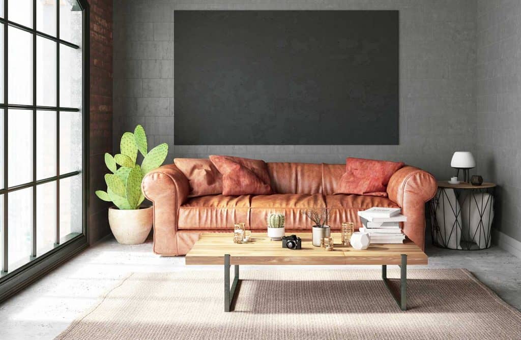 Waiting room with leather sofa and empty frame