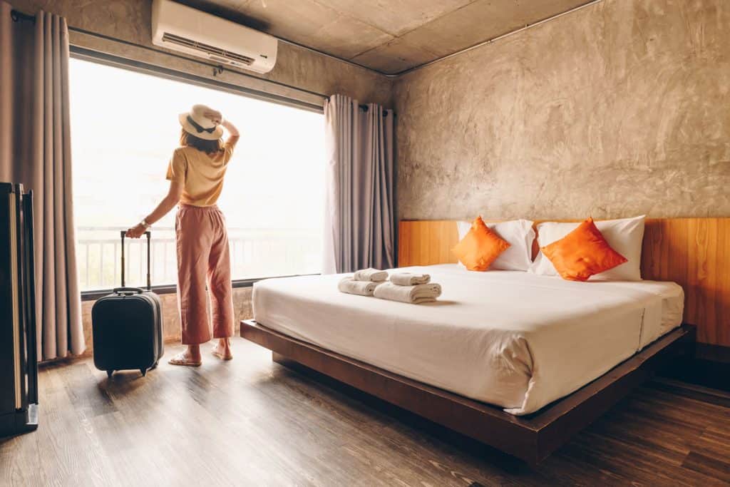 Woman checking the view inside the guest room