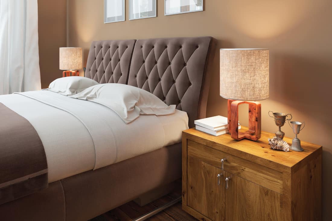 Wooden bedside tables with expressive textures in a modern bedroom, should headboard be against wall