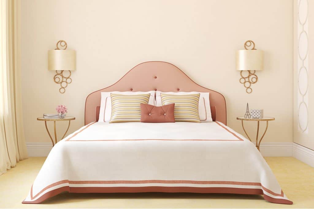 A beige bedroom with floral beddings and a beige curtains