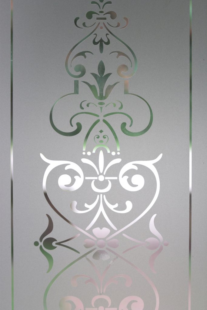 A glass door etched with a floral pattern