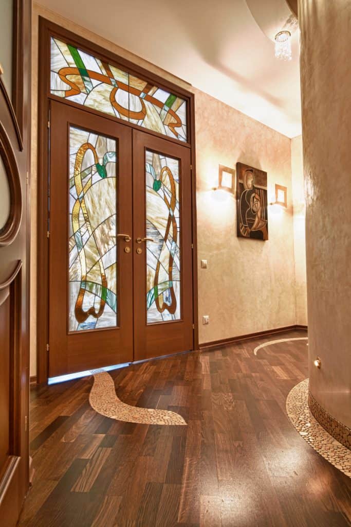 A glass French door with cool designs on the glass