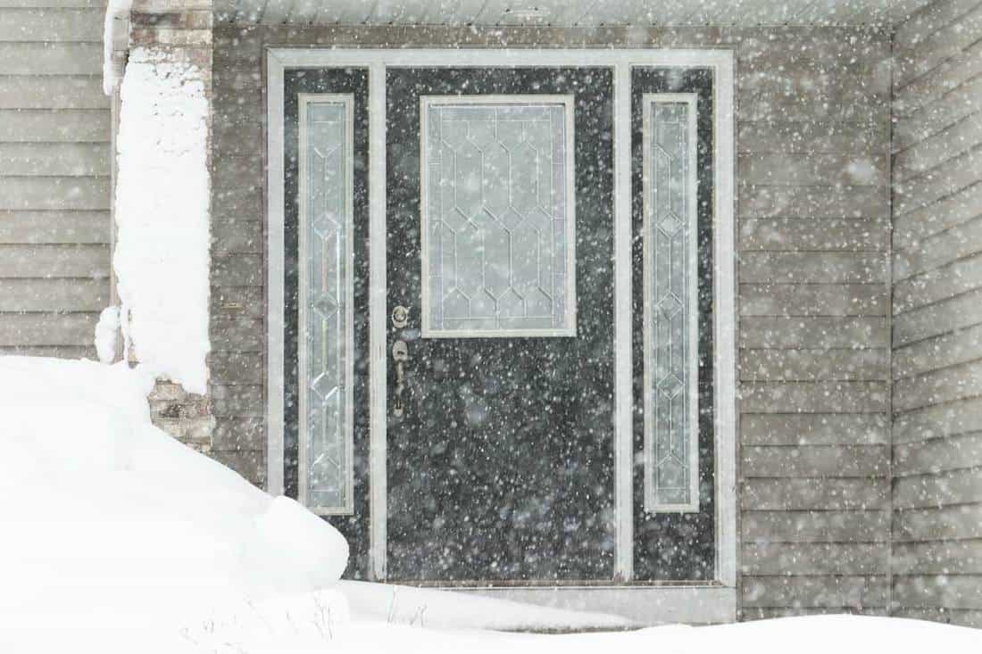 A house entry area during a major winter snowstorm, How Much Does A Storm Door Cost?