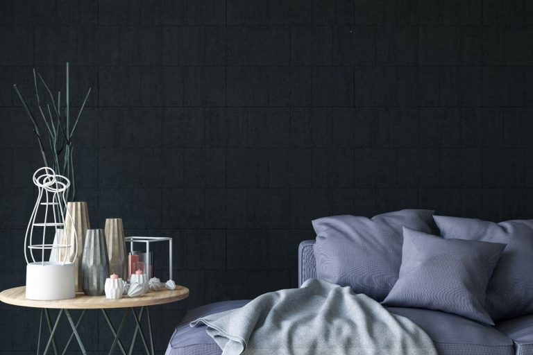 A modern dark themed bedroom with blue bedding sets with a nightstand on the side, How And Where To Store Pillows? [12 Great Suggestions]