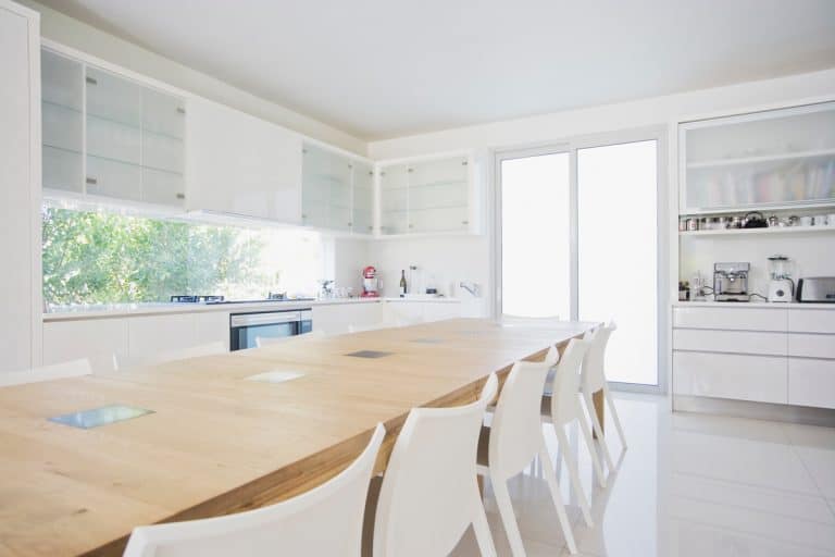 A modern white dining room with a ten seater dining table, How Long Is a 10-Person Table?
