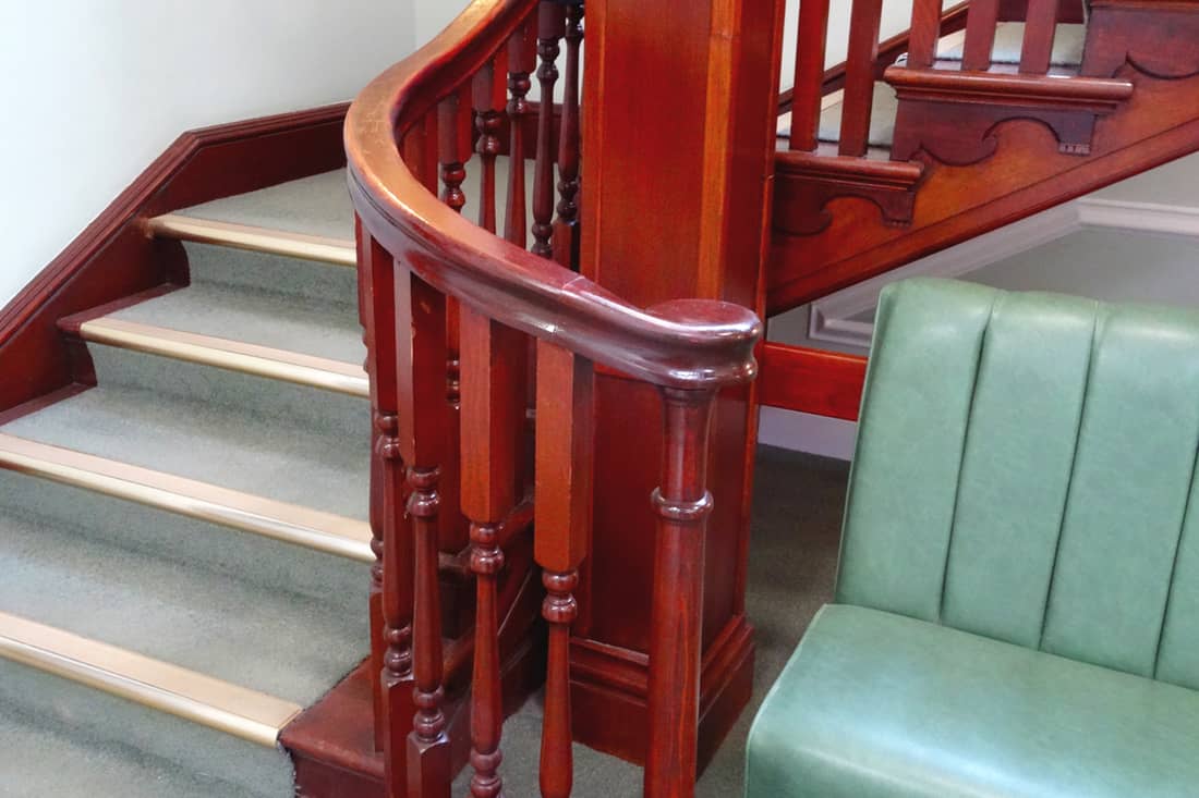Stair spindle colored with a dark brown varnish finish, How To Paint Stair Spindles Without Removing Them?