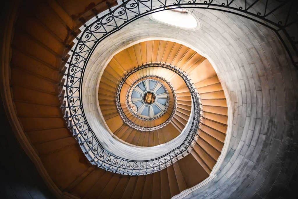 Architecture of a large spiral staircase with beautiful sunlight from outdoor