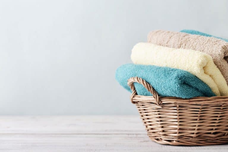 Bath towels placed inside a basket, Bath Sheet Vs Bath Towel: What's the difference?