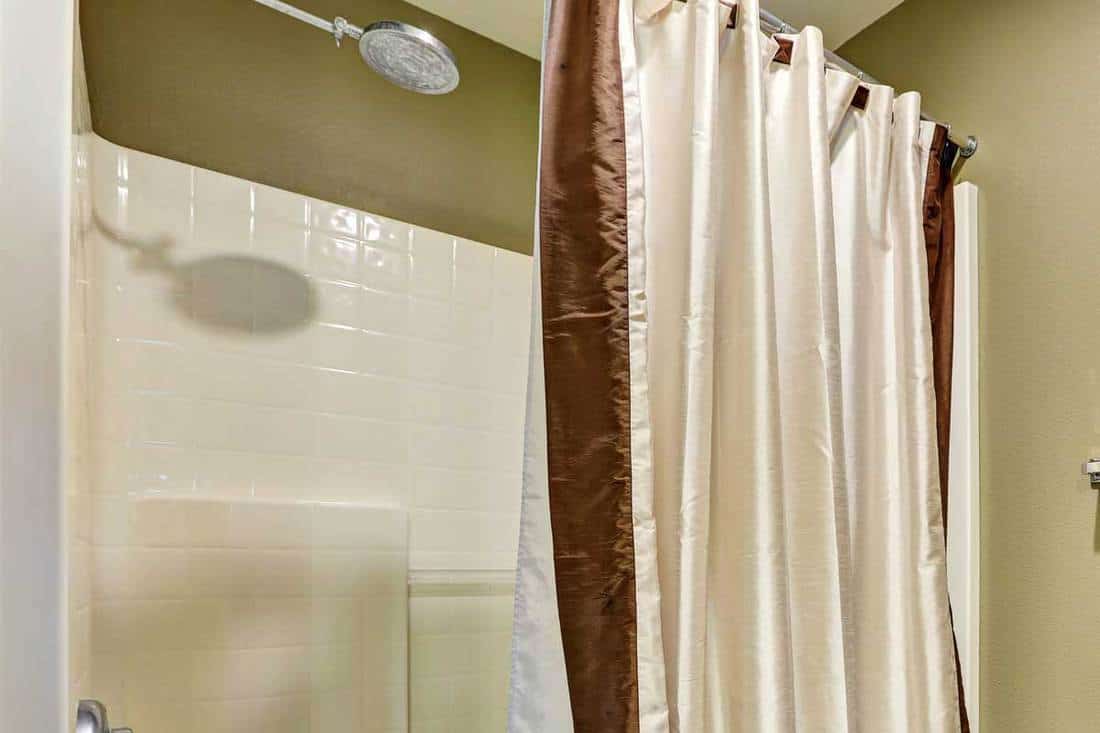 Bathroom shower with tile walls and shower curtain liner