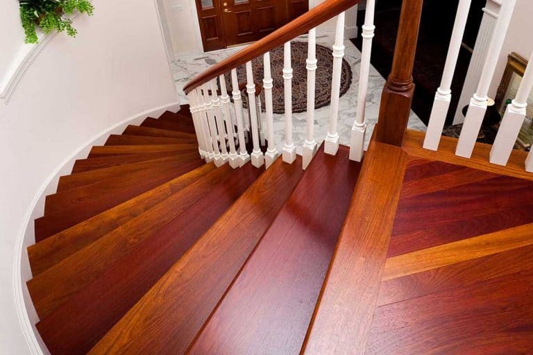 Beautiful winding hardwood staircase in showcase home, 8 Best Types of Flooring for Stairs