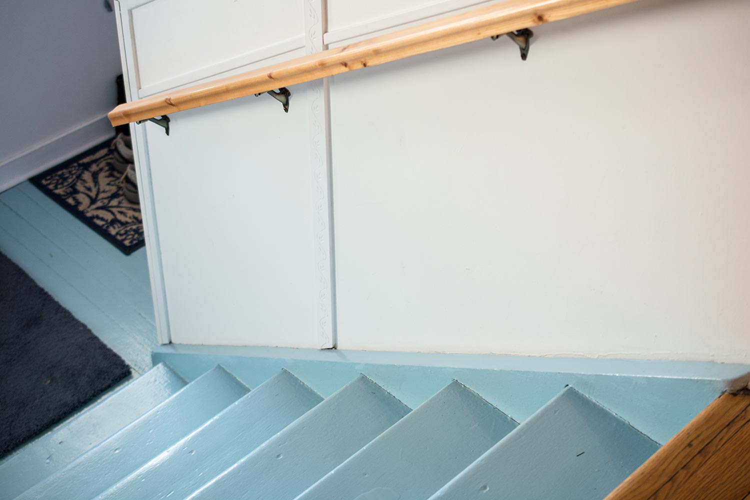 Blue painted stairs in an old school that has been renovated into a home