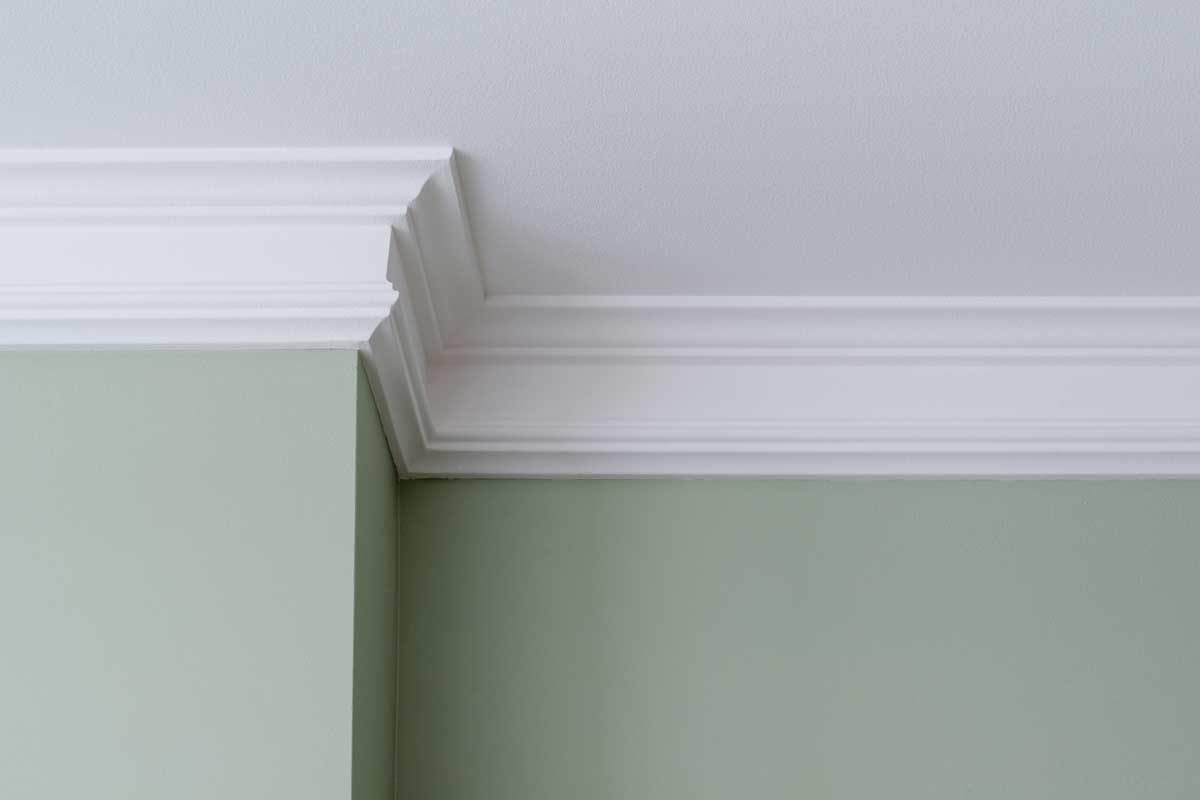 Ceiling moldings in a house with green wall, How To Paint Crown Molding Without Brush Marks