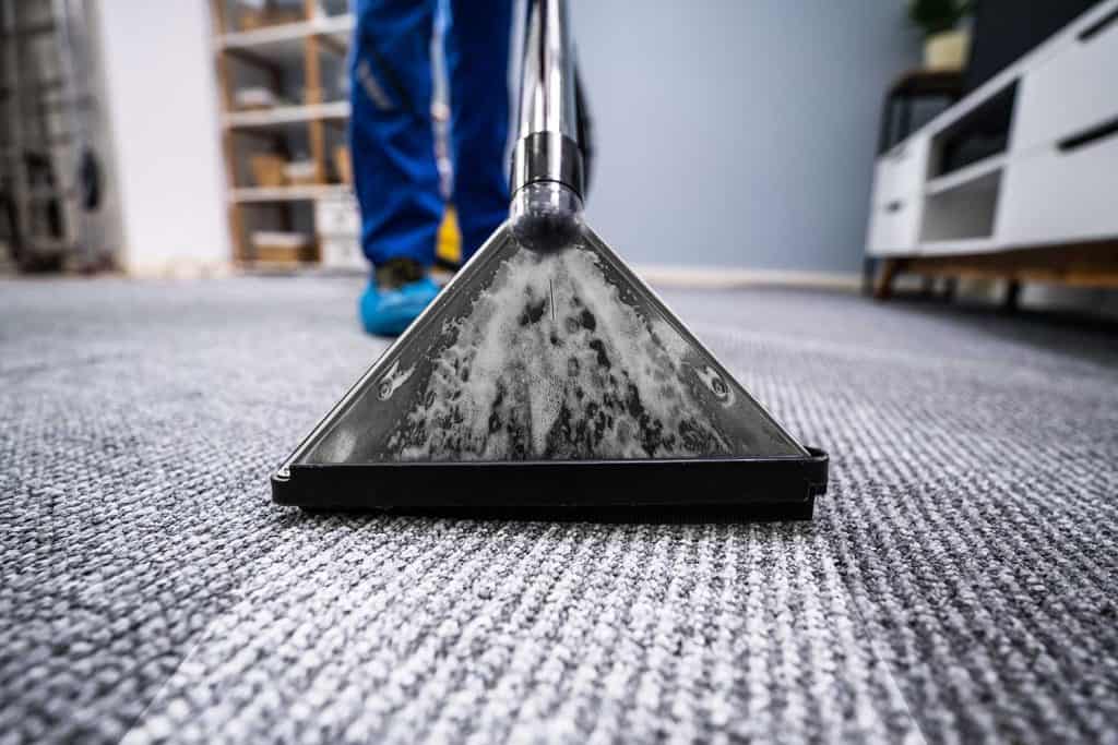 Close-up of a cleaning carpet with vacuum cleaner