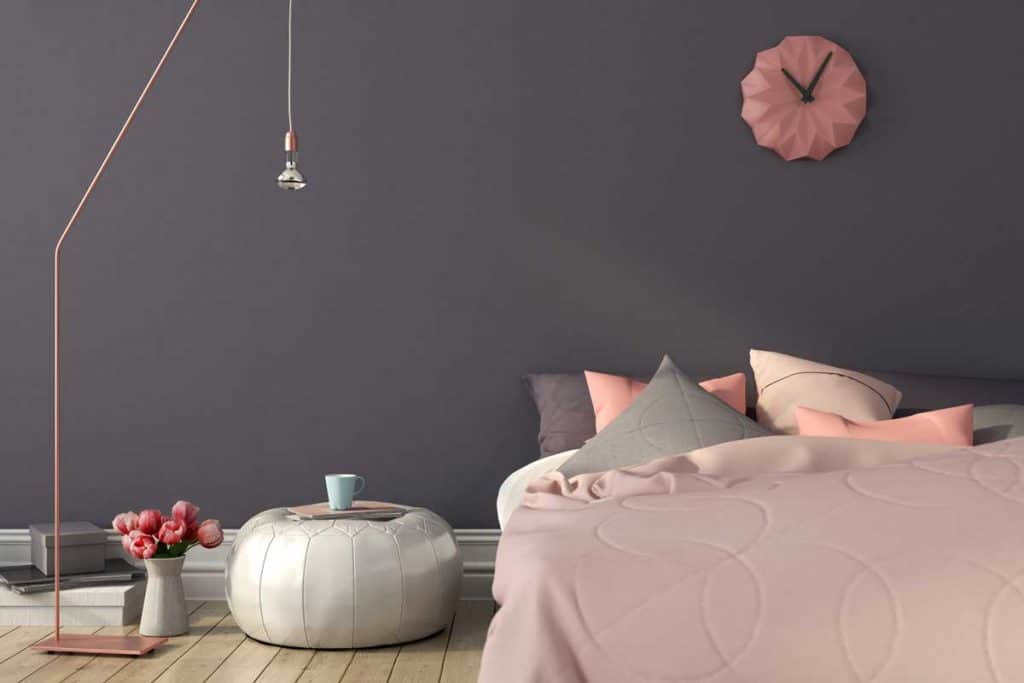 Cozy bedroom in pink and gray color with a stylish copper floor lamp