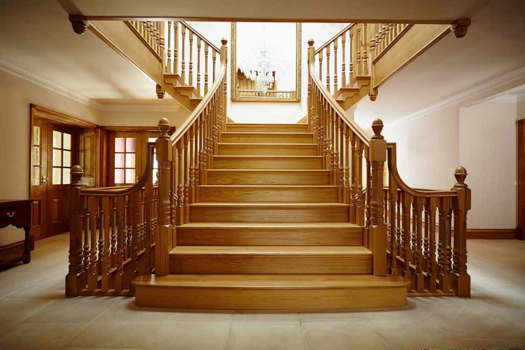 Curved oak staircase in luxury home entrance hall