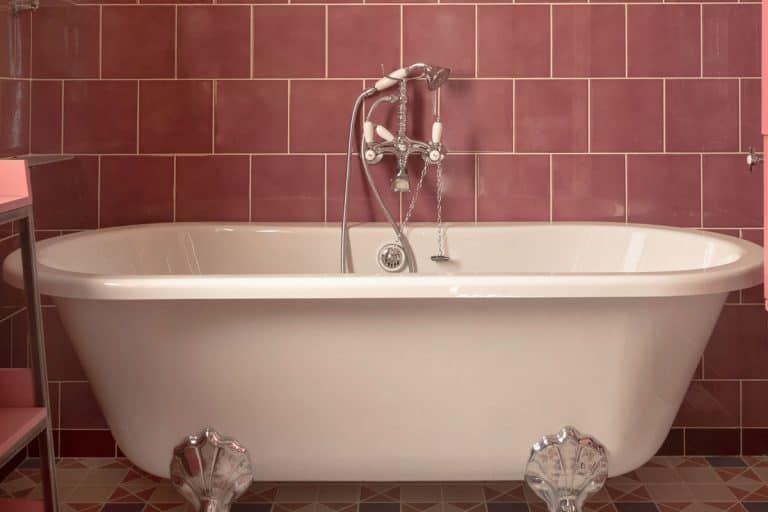 An empty acrylic bathtub with hand shower, Acrylic Bathtubs Pros And Cons: What Homeowners Need To Know
