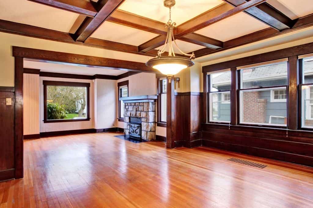 Empty room with wood paneled walls and coffered ceiling
