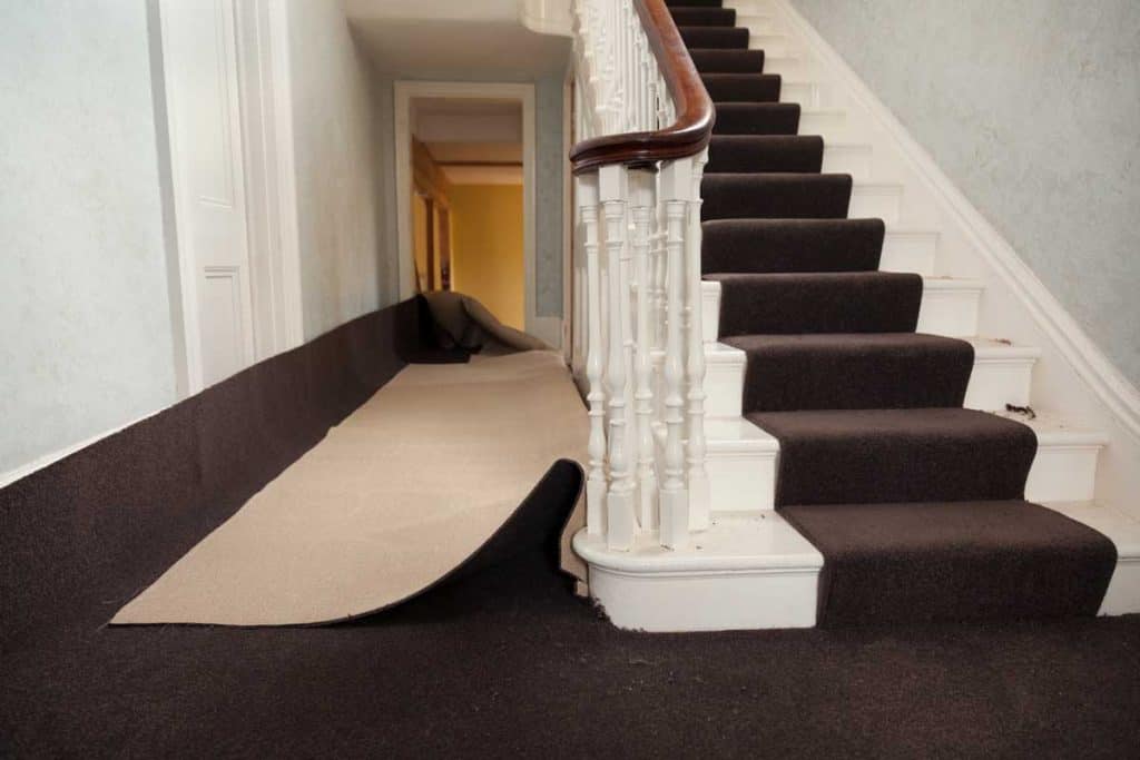 Installation of carpet in hallway of house