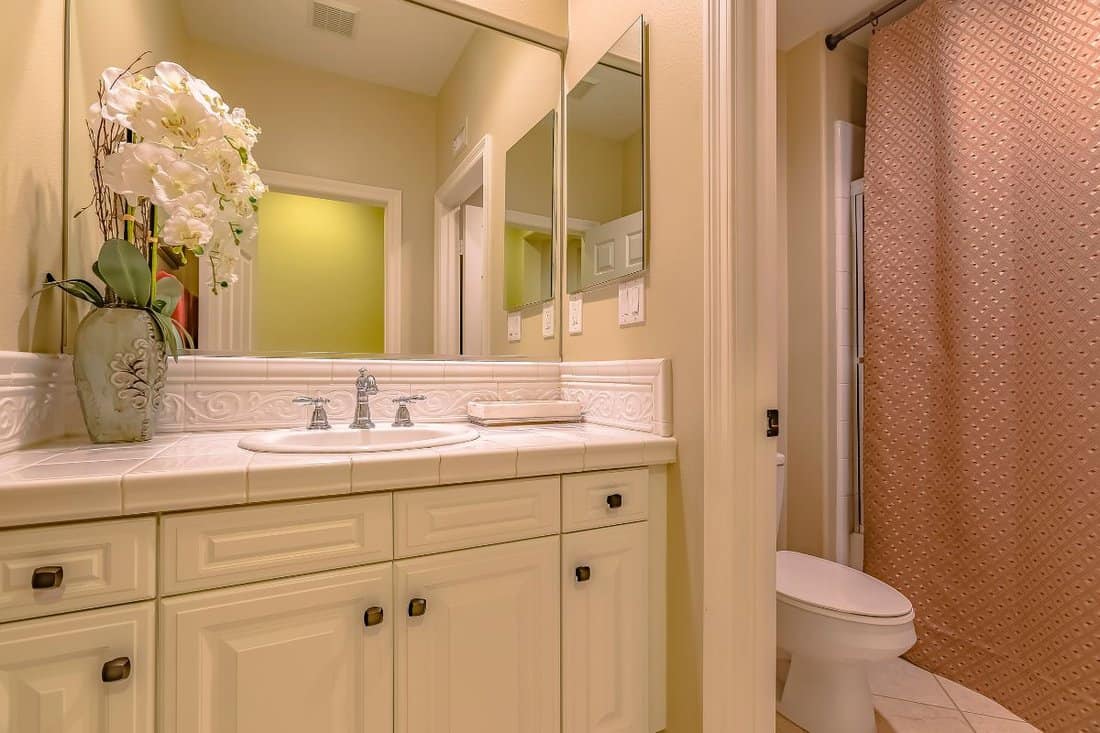 Interior of a small bathroom with a single sink vanity area and toilet