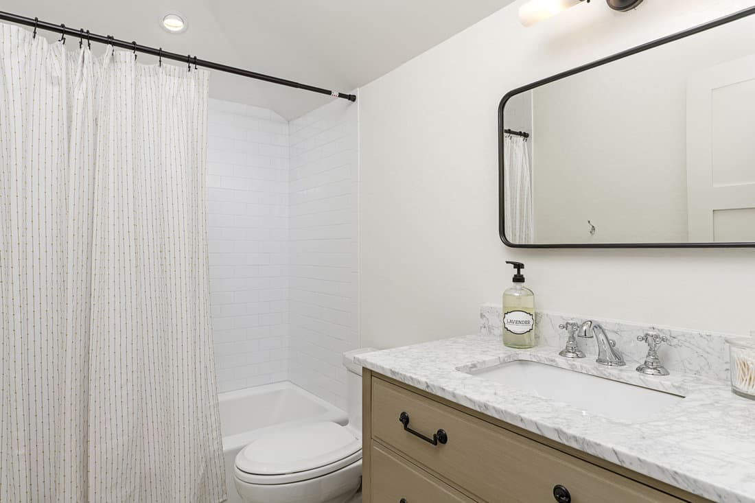 Interior of a white modern bathroom with a white patterned shower liner, 5 Best Shower Curtain Liners To Avoid Mildew And Moldac