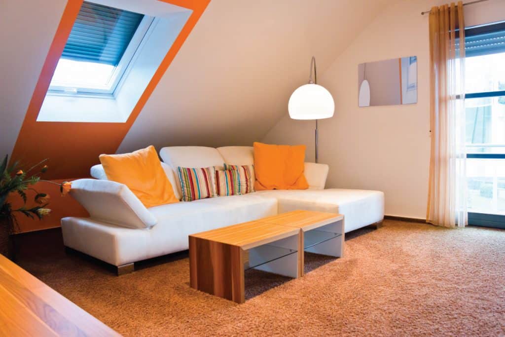 Living room of a attic apartment with accented colors