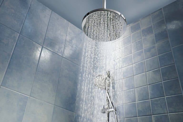 Low angle of running water from shower head in a cool coloured shower, how high should shower controls and shower head be