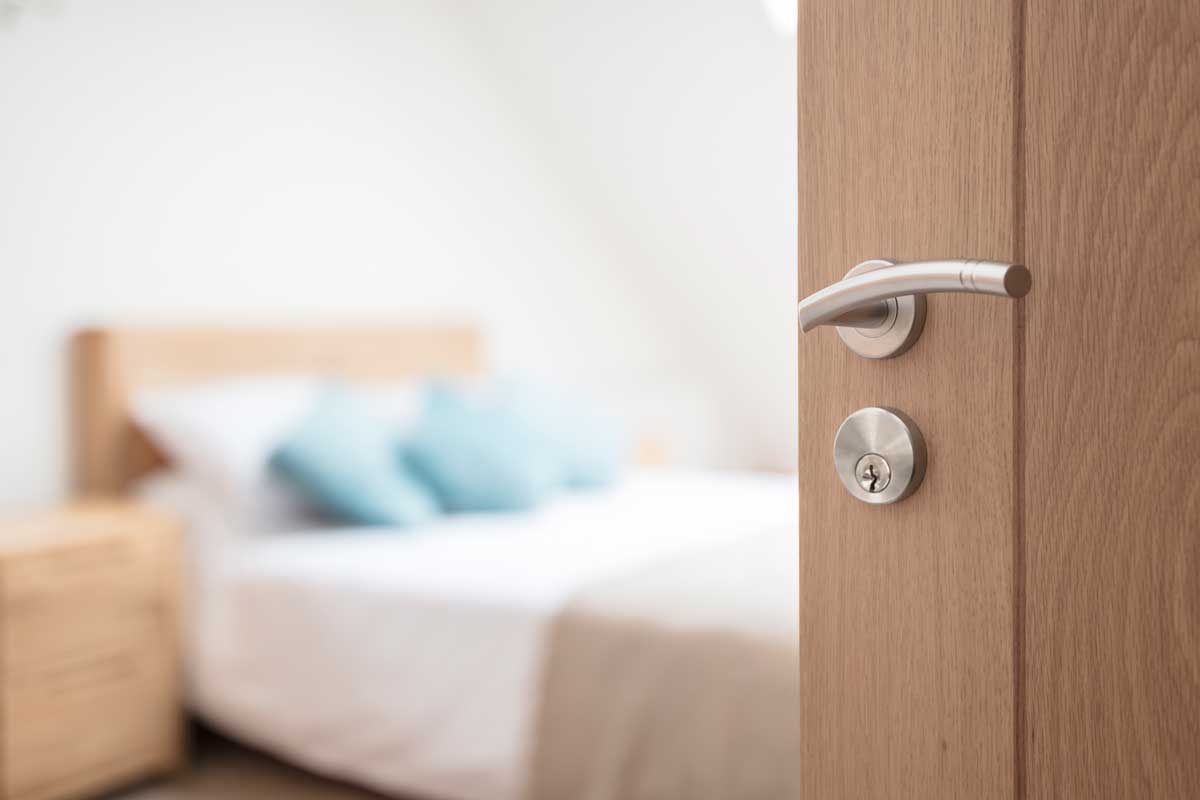 Open door of an apartment bedroom, Can Bedroom Doors Open Out [Here's why yours shouldn't]