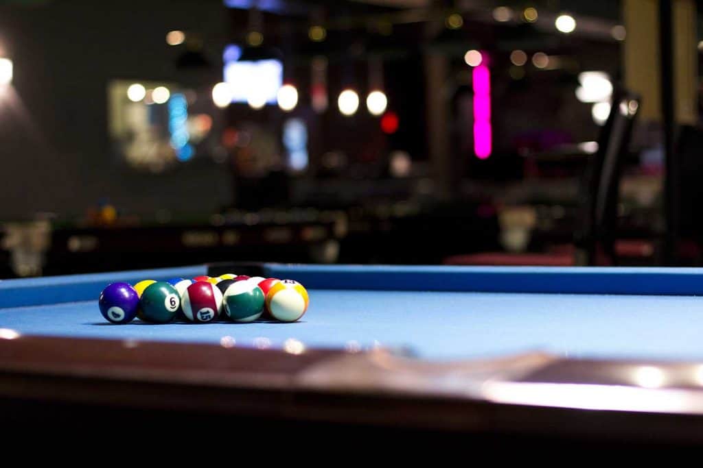Pool balls on a blue table with balls