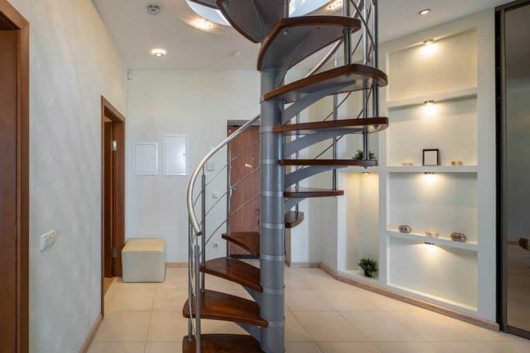 A spiral staircase to second floor in hall of modern luxury apartment, How Big Is A Spiral Staircase?
