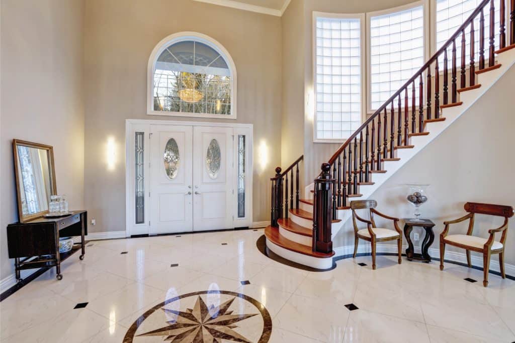 Stunning two story entry foyer with marble mosaic tile and nautical star