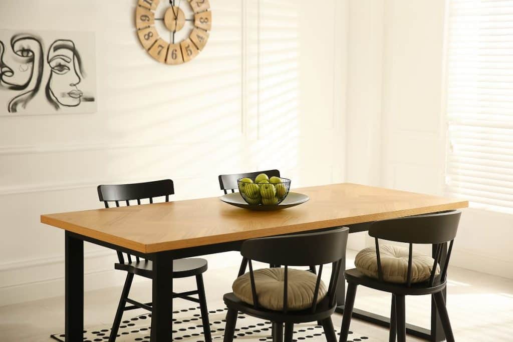 Stylish wooden dining table and chairs in room.