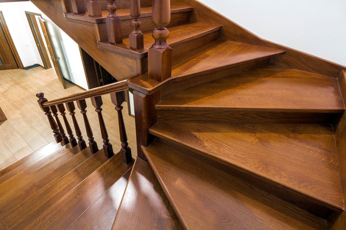 Swirling wooden staircase leading to the second floor of a house