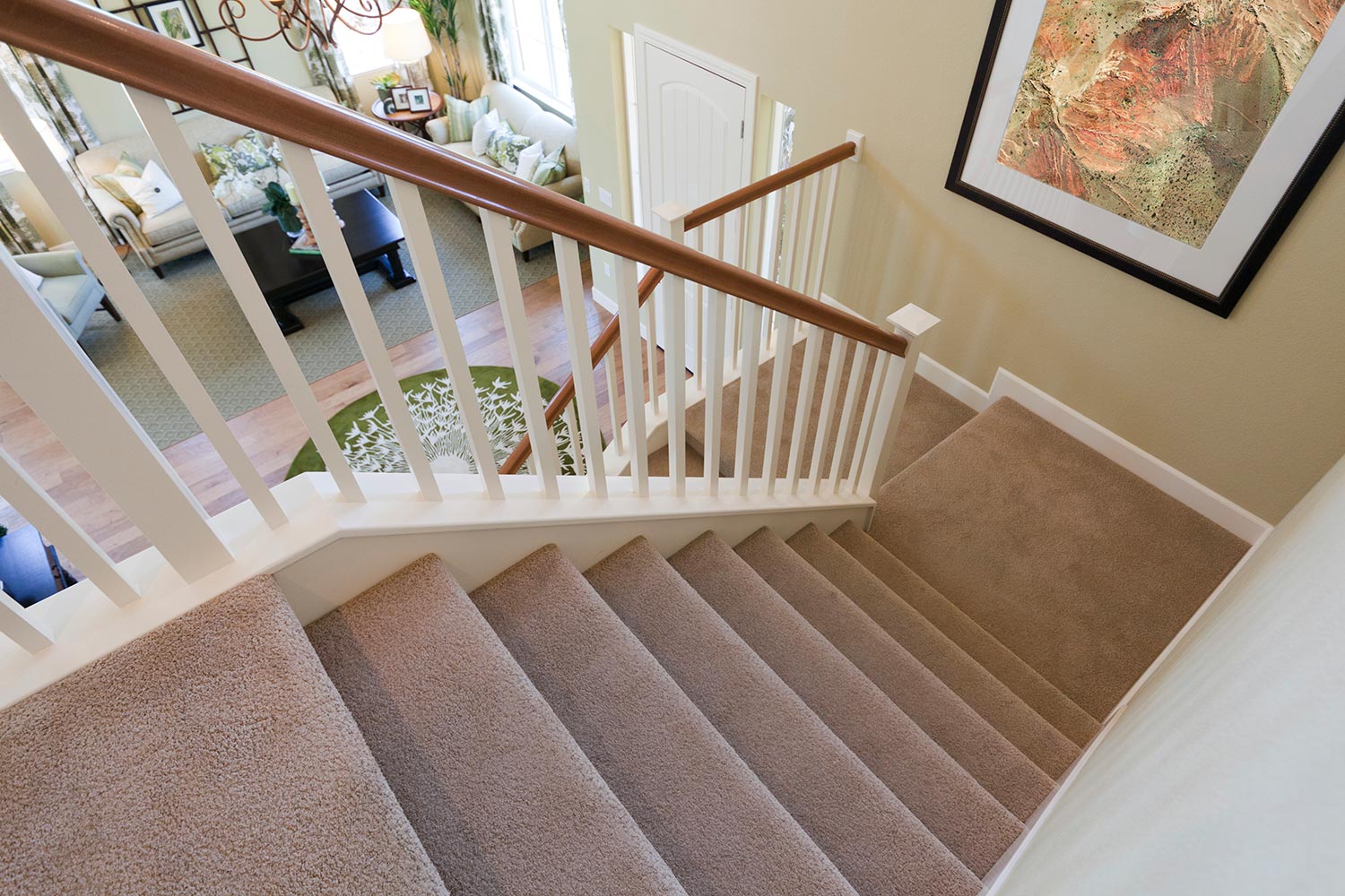 View down interior carpeted stairs in a modern American home