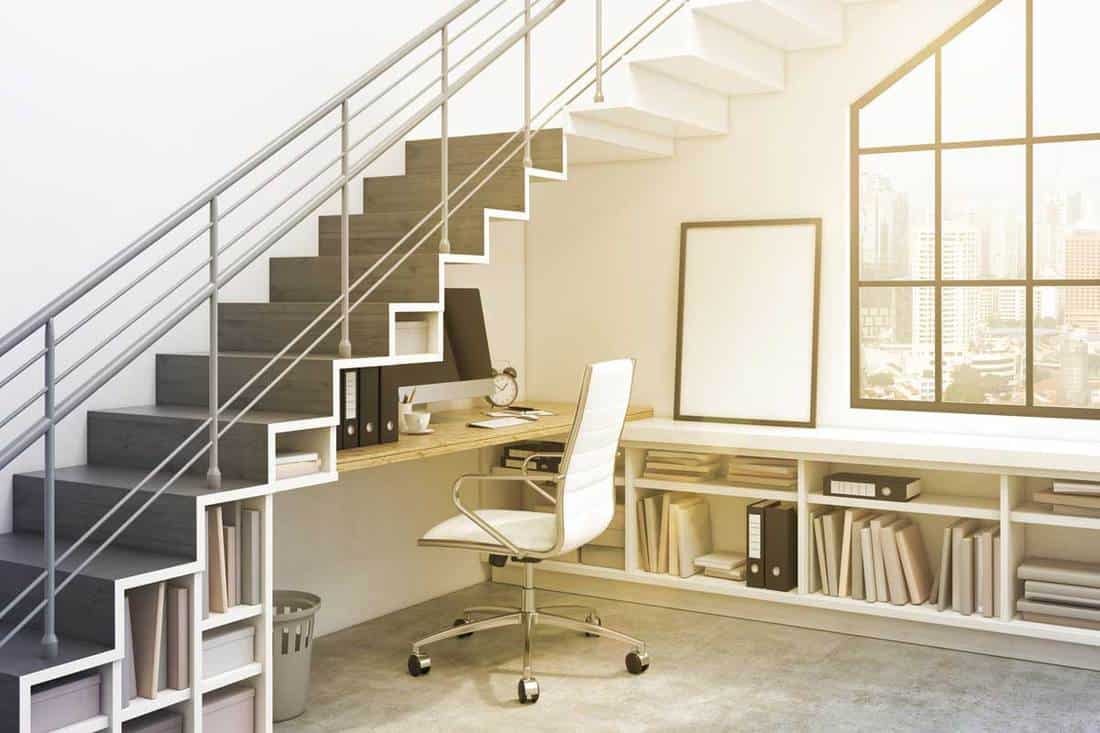 A workplace with a computer and shelves under the stairs, How to Build Shelves Under Stairs [3 Easy Steps]