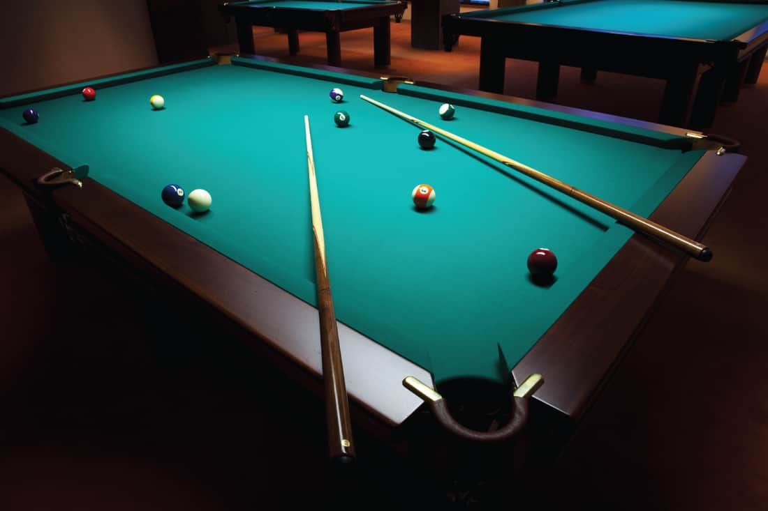 billiard table in a dark game room