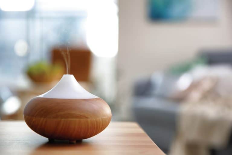 A wooden themed plug-in scent diffuser turned on and functioning, 6 Best Plug-In Natural-Scented Air Fresheners For Your Home