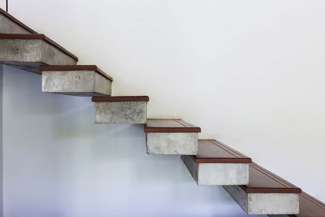 floating staircase on white mortar wall, design of modern home