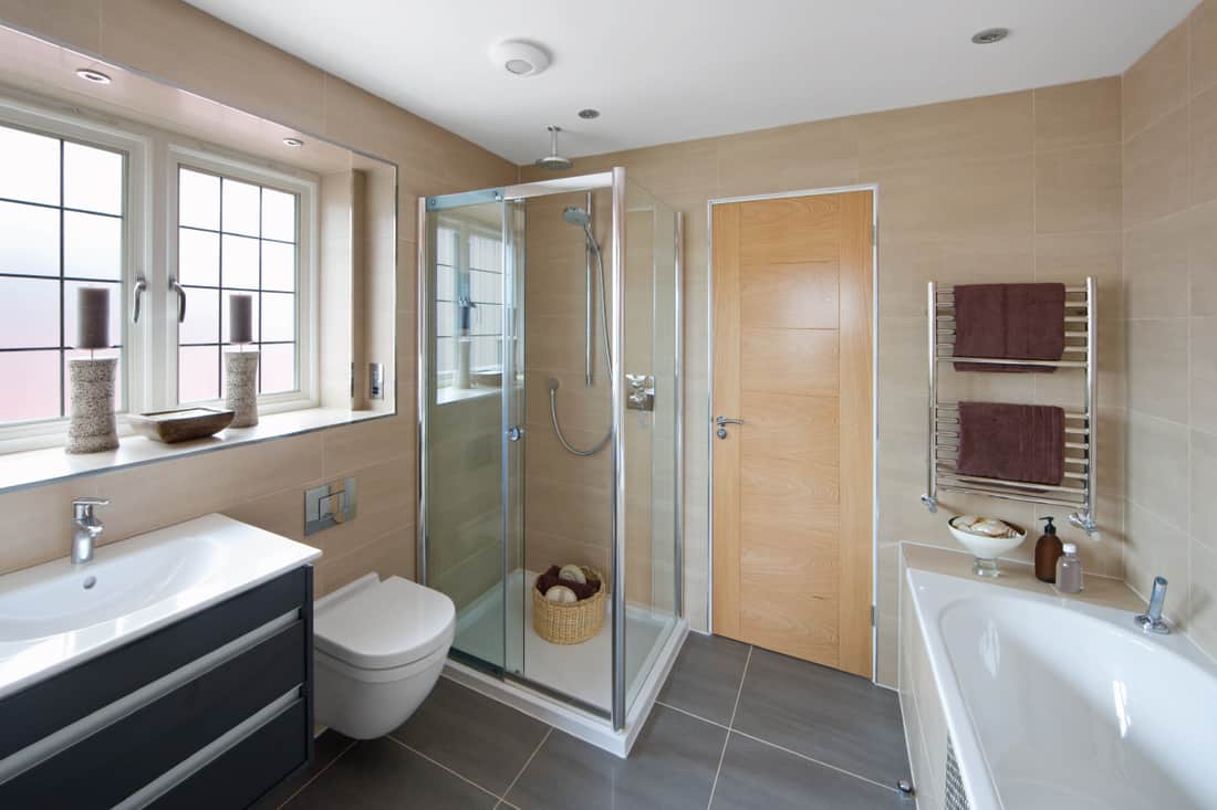 guest bathroom in a luxury house with toilet bathtub and sink, what is the minimum shower door width