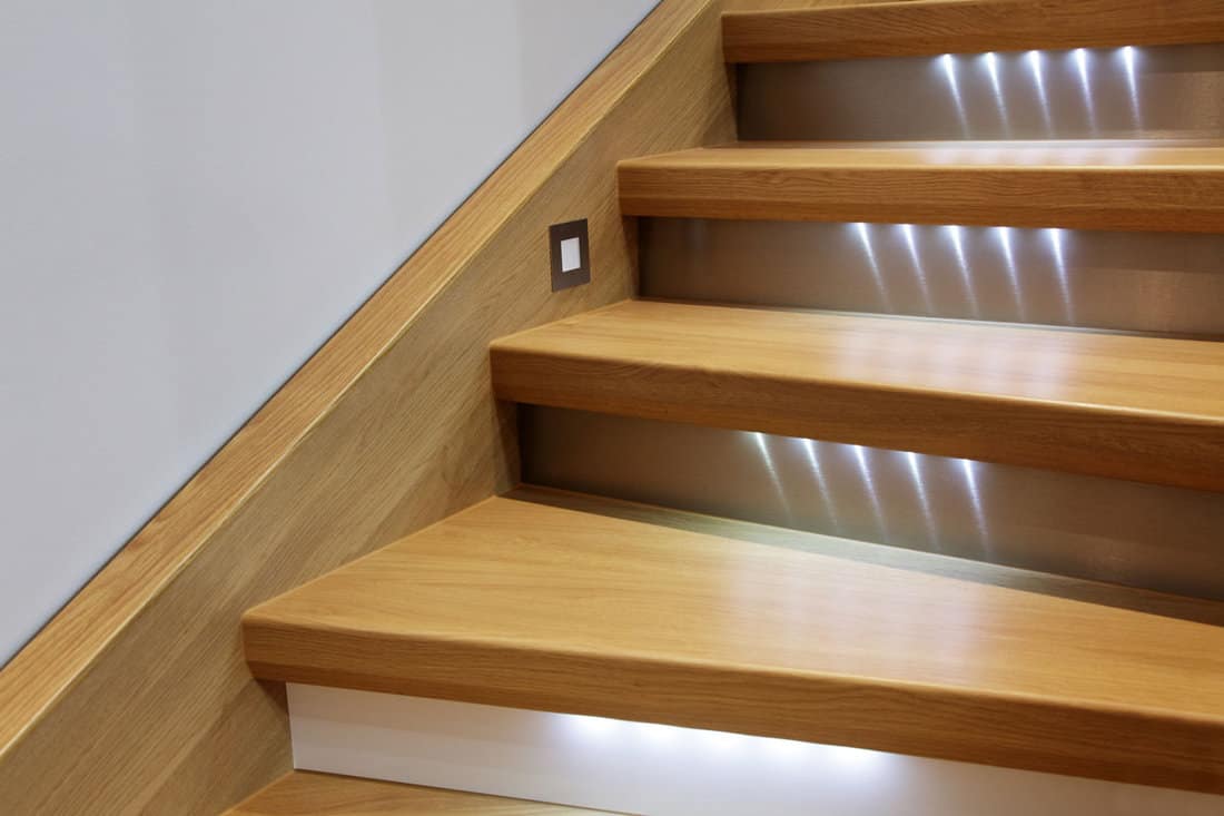 staircase with wooden steps and illumination