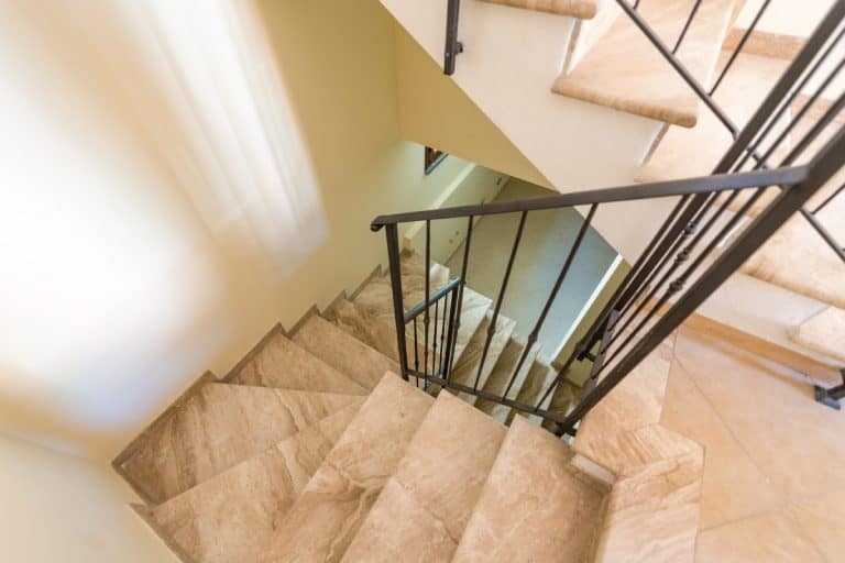 Tiled semi spiral staircase leading to basement, 6 Best Flooring Types For Basement Stairs